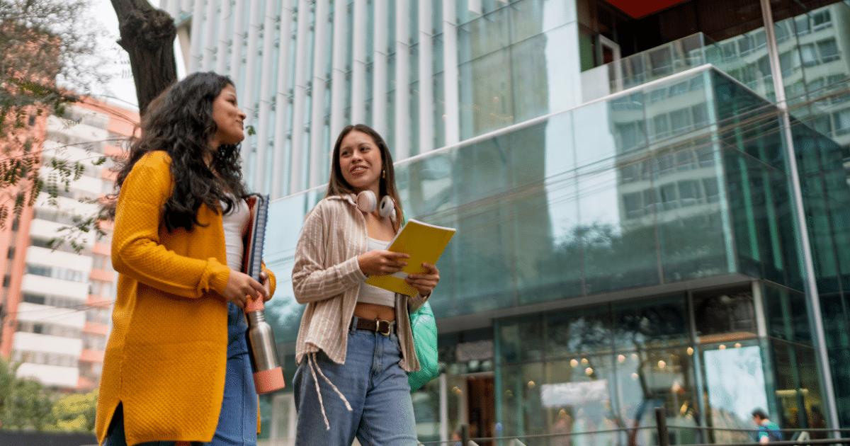 Parent and student walking together on a college campus visit, planning their college search