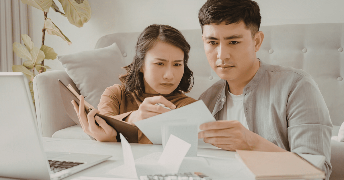 Parents and high school student reviewing college financial aid documents together at home