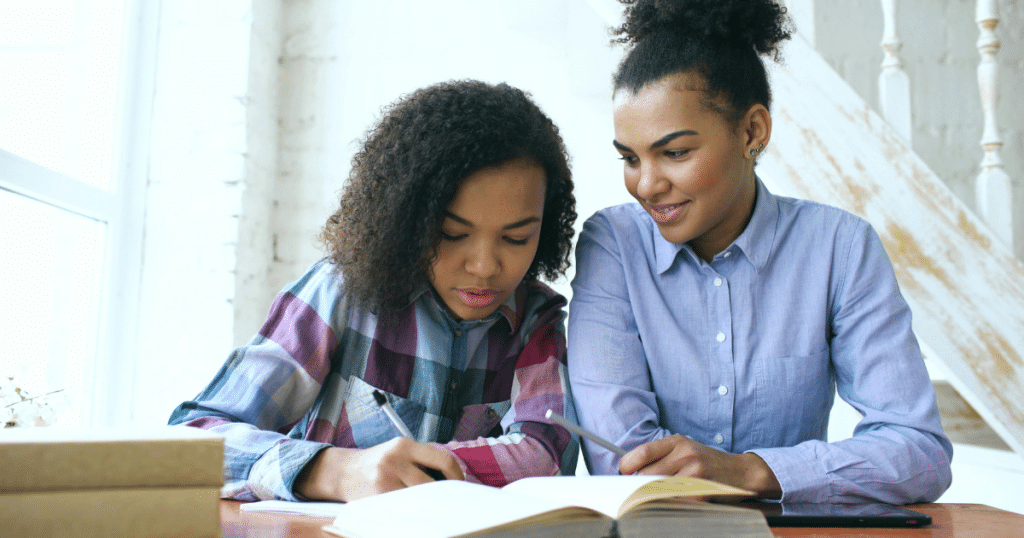 Parent and high school student reviewing college prep planner together
